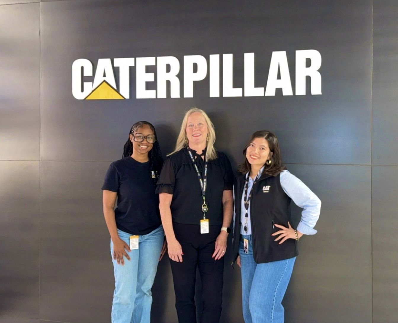 a group of women standing in front of a sign