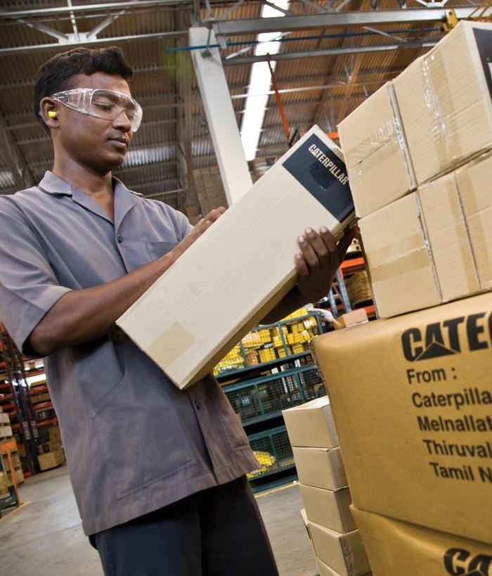 a person wearing safety goggles and holding a box