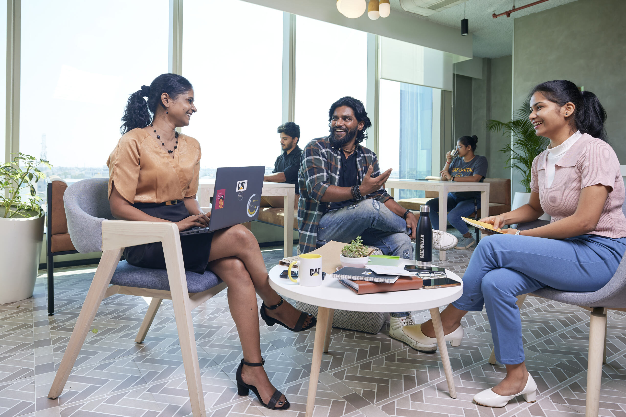 a group of people sitting in chairs and talking