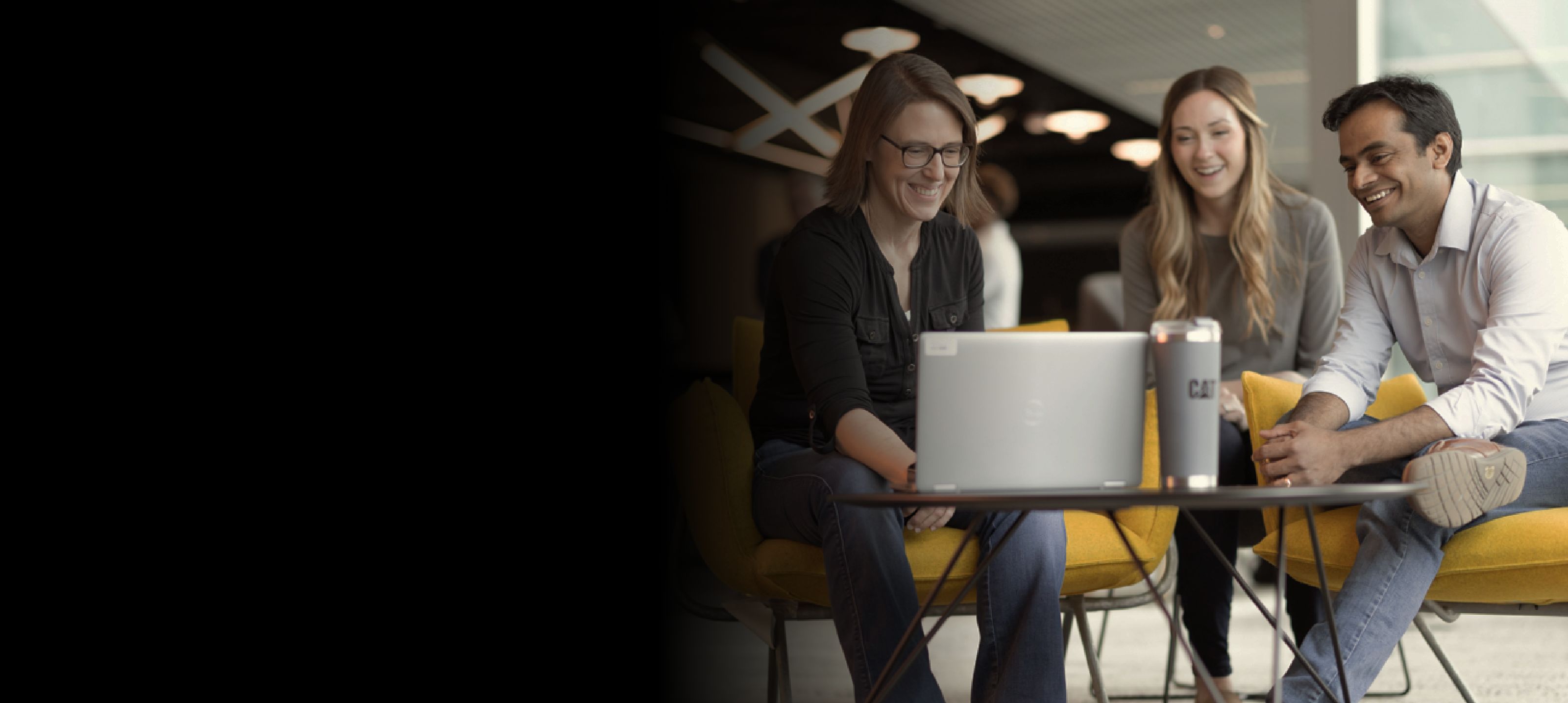 a person sitting on a chair using a laptop