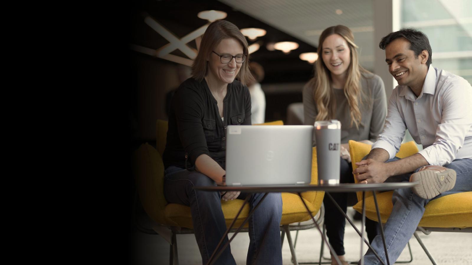 a person sitting on a chair using a laptop