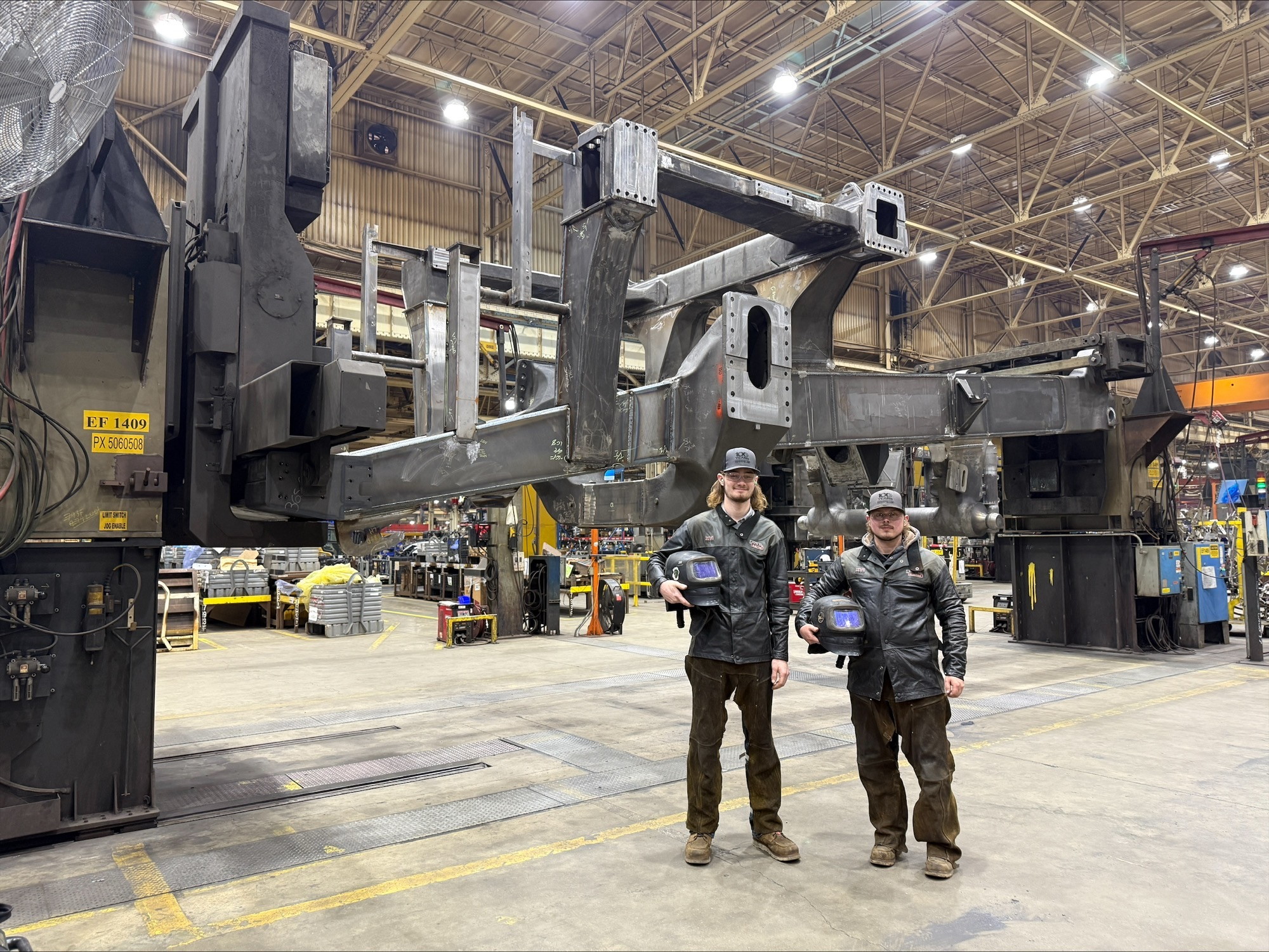 two men standing in a factory