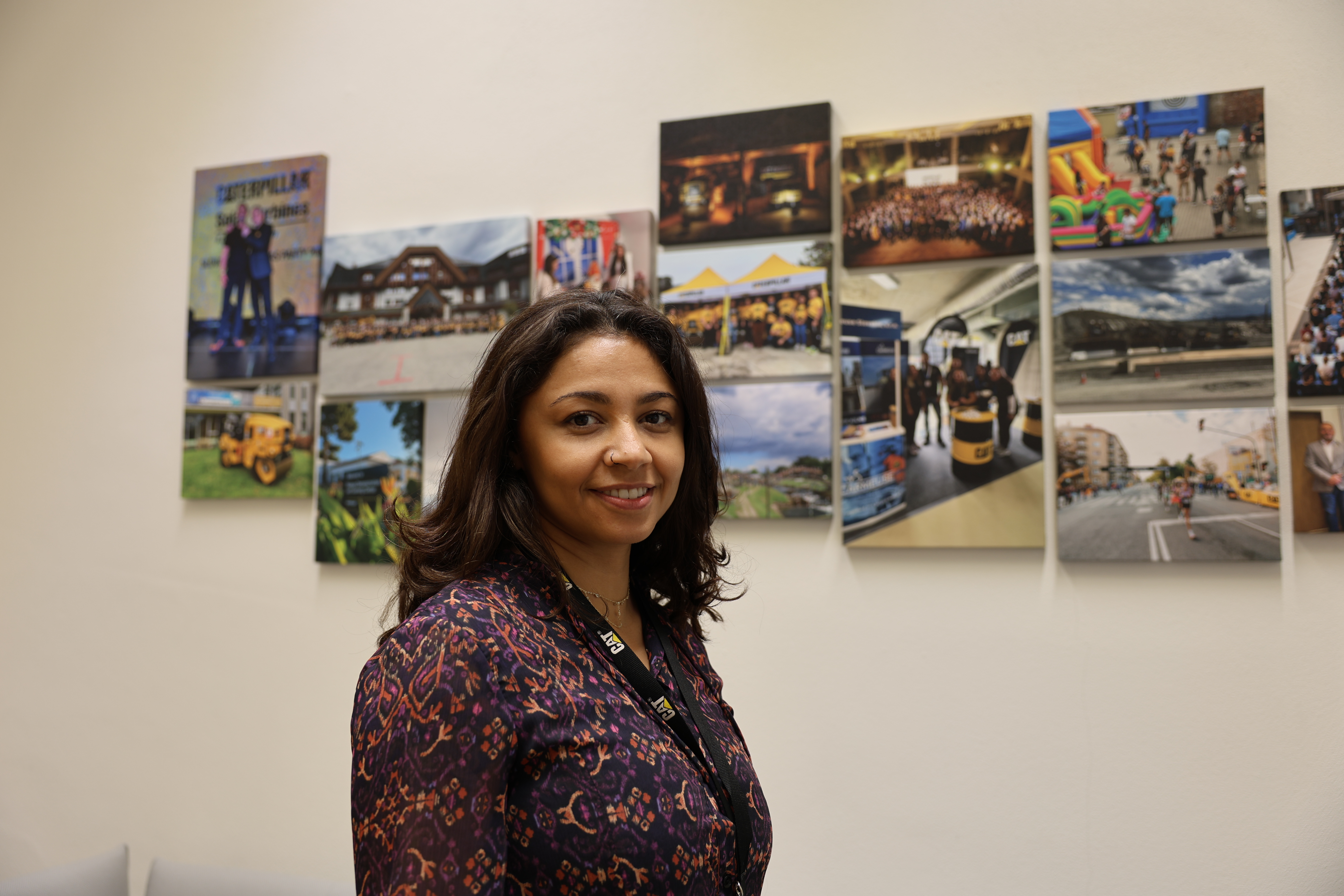 a person standing in front of a wall of pictures