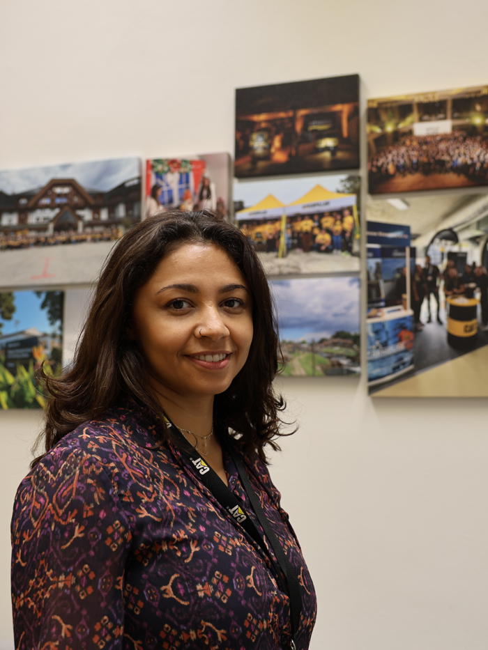 a person standing in front of a wall of pictures