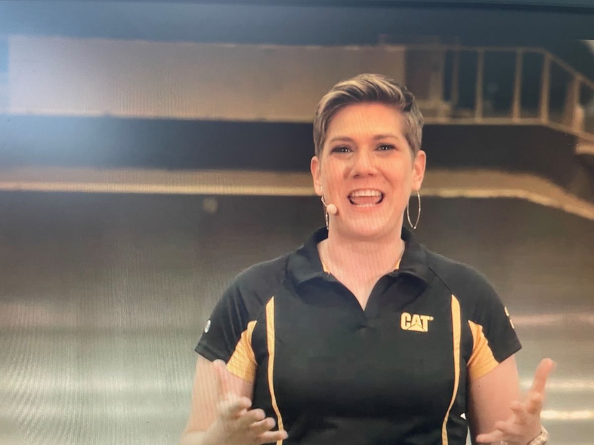 a person with short hair wearing a black and yellow shirt