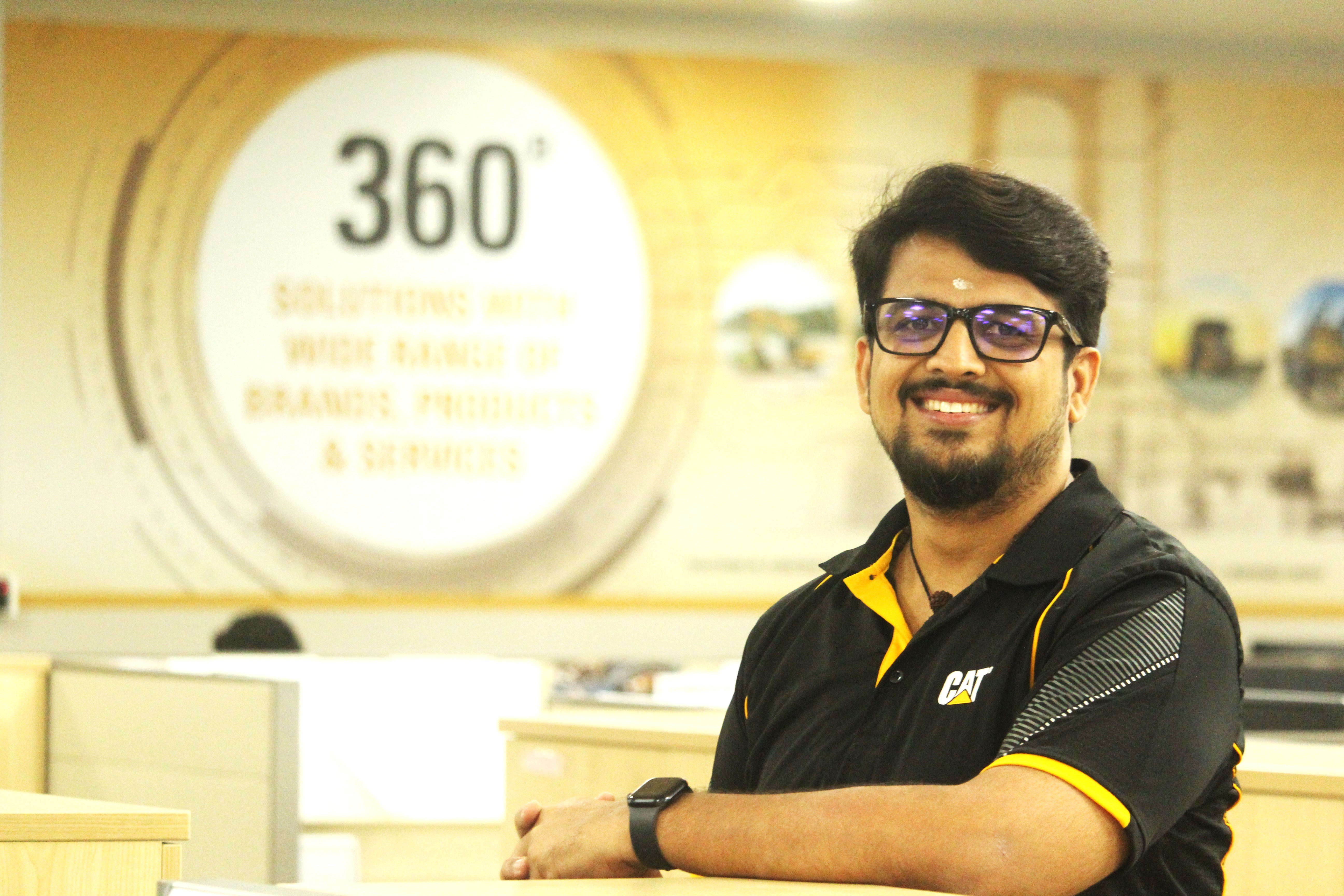 a person wearing glasses and smiling