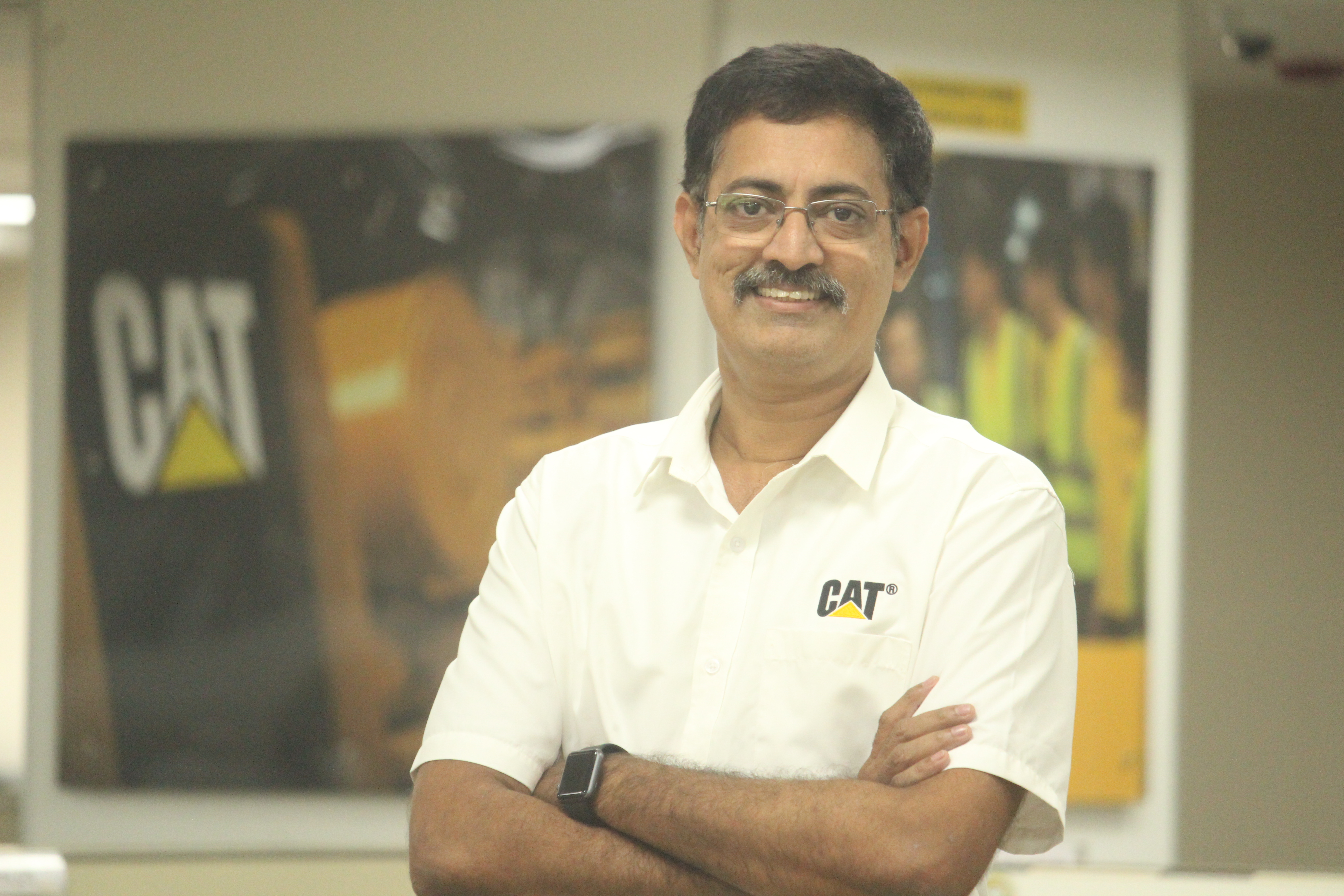 a person with glasses and mustache wearing a white shirt