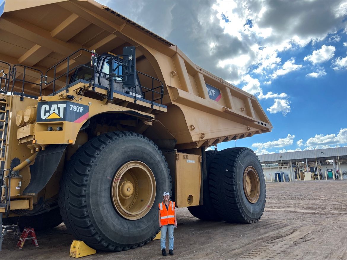 a person standing in front of a large truck