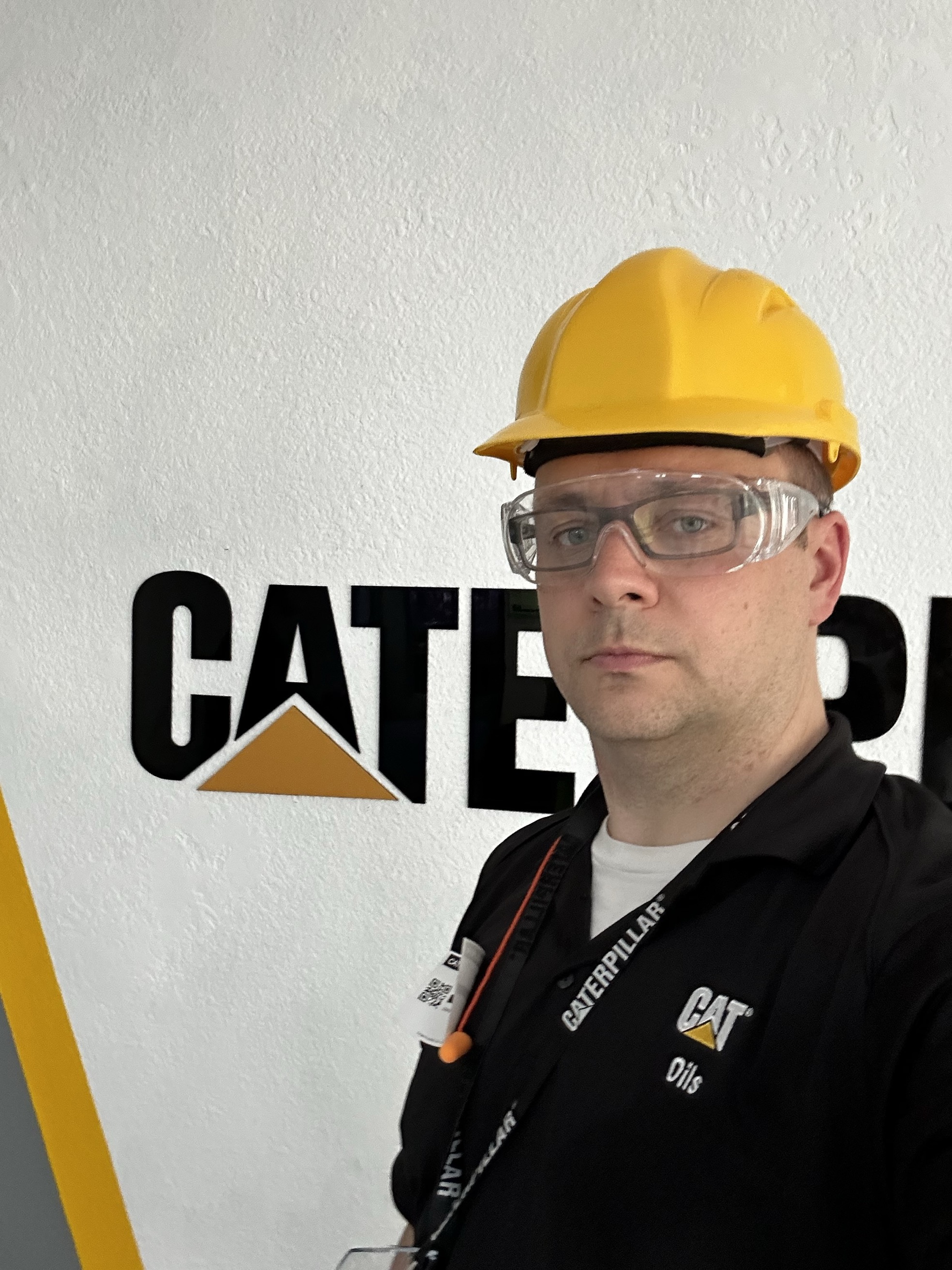 a person wearing a hard hat and glasses