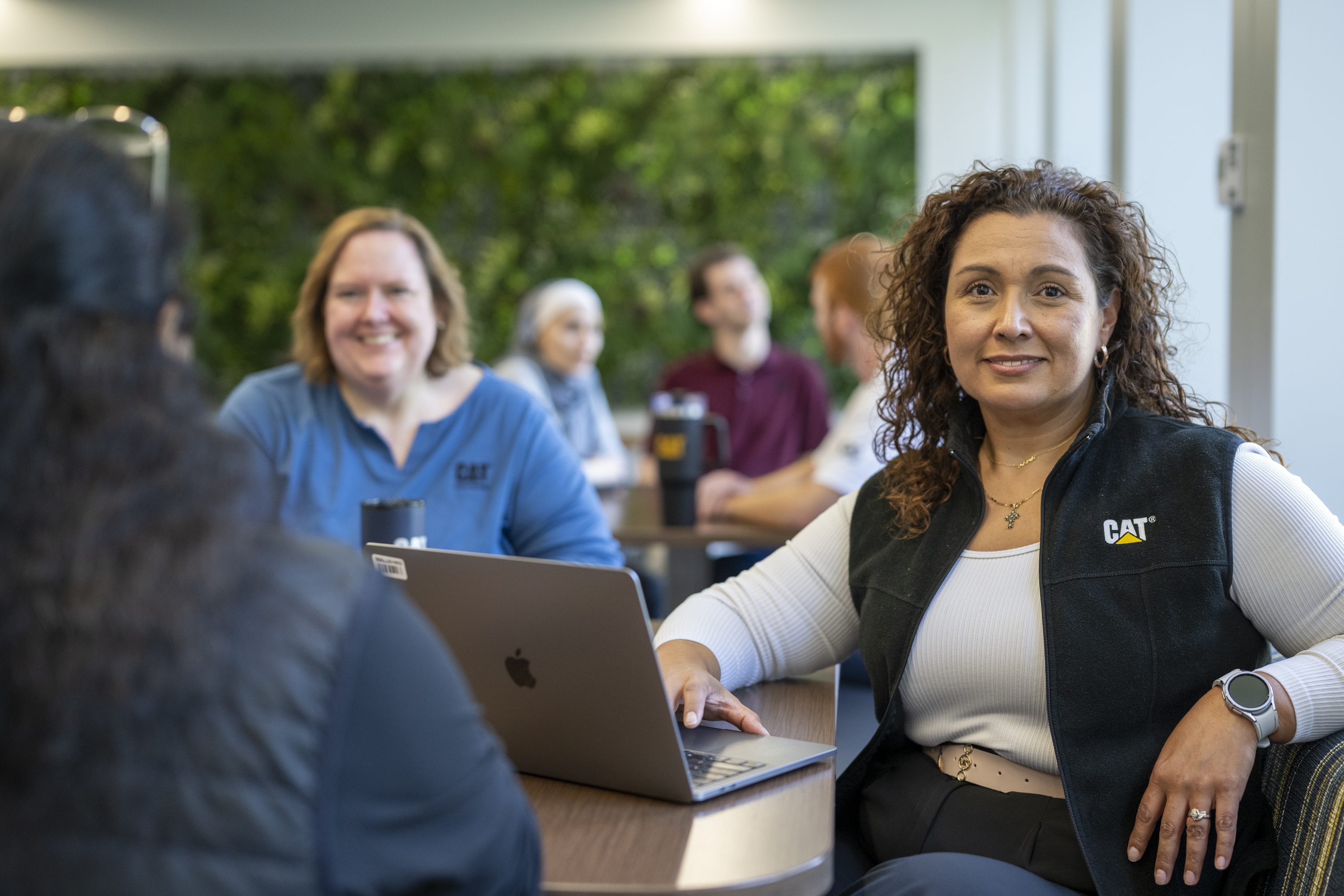 a person sitting at a table with a laptop