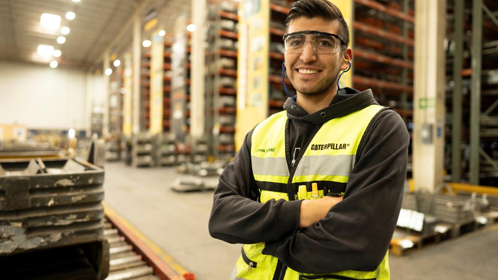 a person wearing safety goggles and a yellow vest